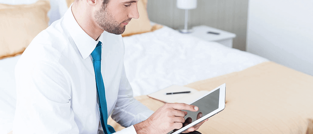 Hotel guest using tablet to cast screen to Hotel TV